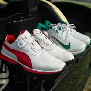 A pair of Puma golf shoes on a golf cart