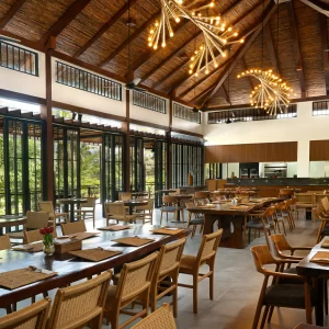 A large dining room in a restaurant, highlighted by a substantial dining table set for guests.