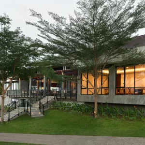 A club house (country club) featuring a golf cart parked outside, indicating a connection to nearby golf courses or recreational areas