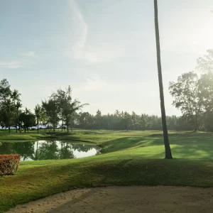 An expansive golf course showcasing a smooth green grass field, ideal for golfing activities